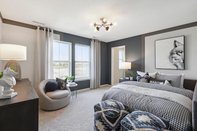 carpeted bedroom with a notable chandelier