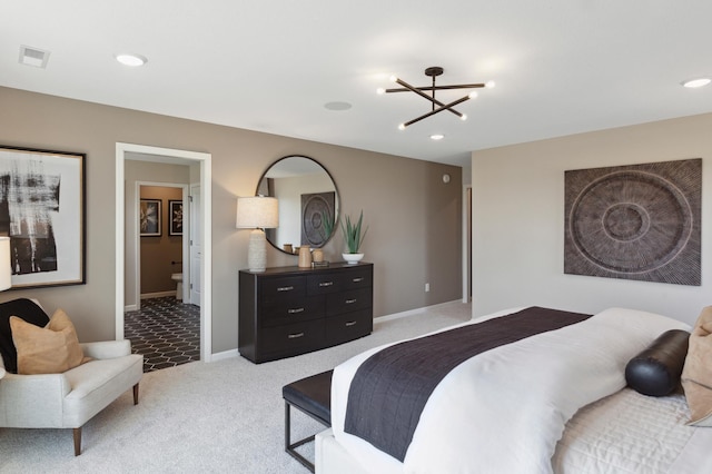 carpeted bedroom with an inviting chandelier