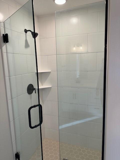 bathroom featuring an enclosed shower