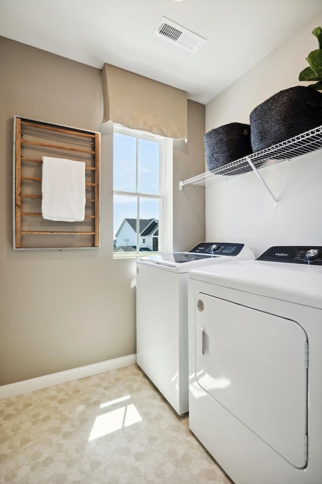 washroom featuring washer and clothes dryer