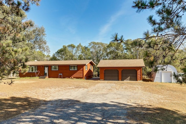 ranch-style home with an outbuilding and a garage