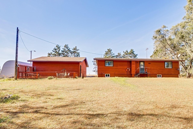 rear view of house featuring a yard