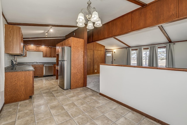 kitchen featuring pendant lighting, appliances with stainless steel finishes, a chandelier, and light tile patterned flooring