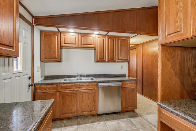 kitchen with dishwasher, sink, and light tile patterned floors