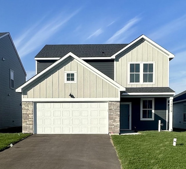 view of front of home with a garage and a front yard