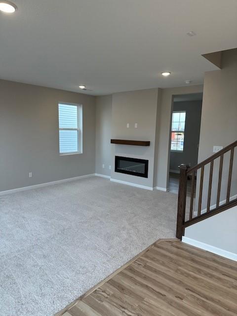 unfurnished living room featuring carpet flooring