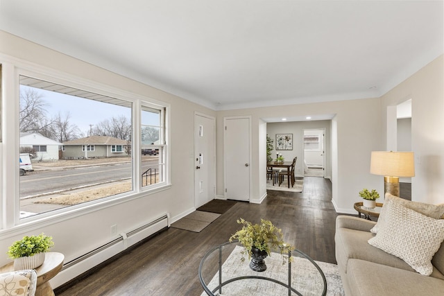 living room with baseboard heating and dark wood-type flooring