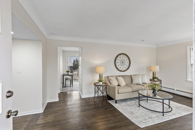 living room featuring a baseboard heating unit and dark hardwood / wood-style flooring