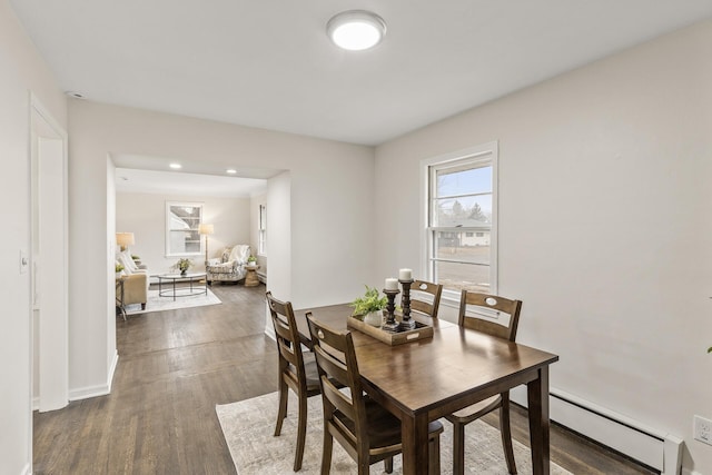 dining room featuring baseboard heating and dark hardwood / wood-style floors