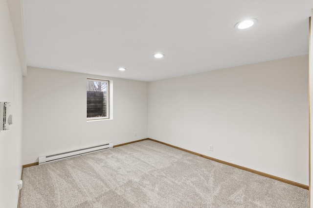 empty room with carpet floors and baseboard heating