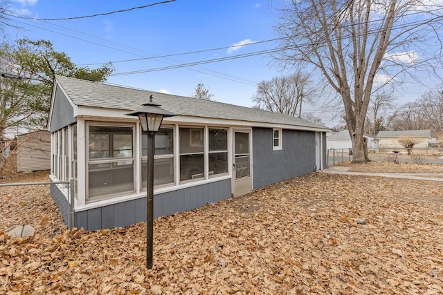 view of property exterior featuring a sunroom