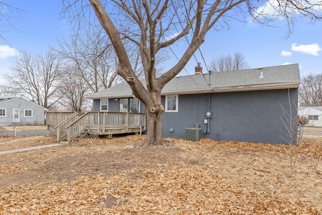 rear view of property with a wooden deck and central AC unit