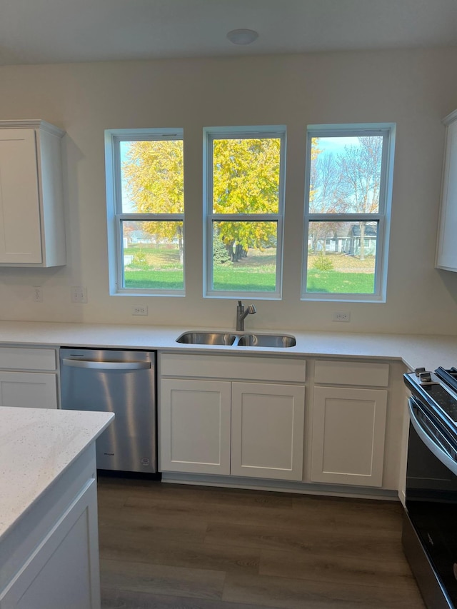 kitchen featuring stainless steel appliances, sink, dark wood-type flooring, and white cabinets