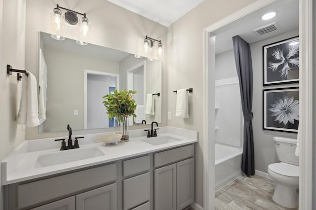 full bathroom with washtub / shower combination, vanity, and toilet