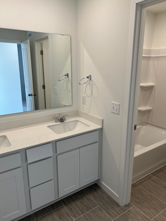 bathroom featuring vanity and  shower combination