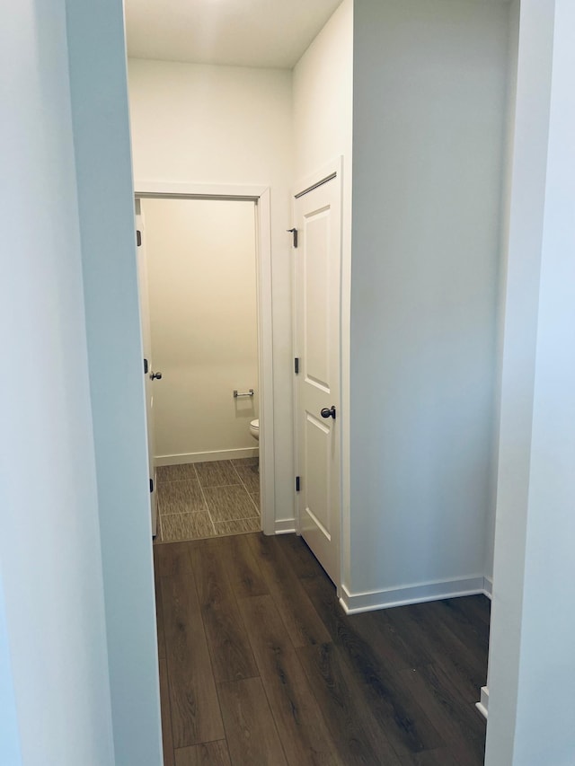 hall with dark hardwood / wood-style floors