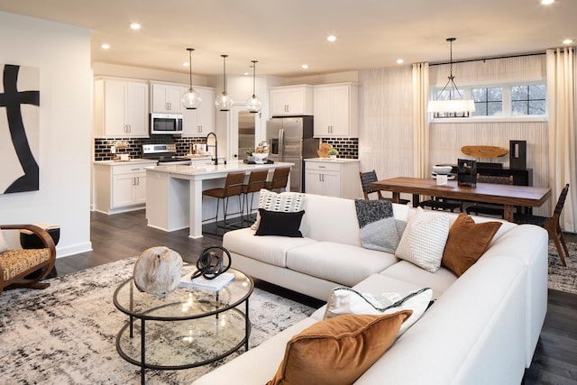 living room with sink and dark hardwood / wood-style floors