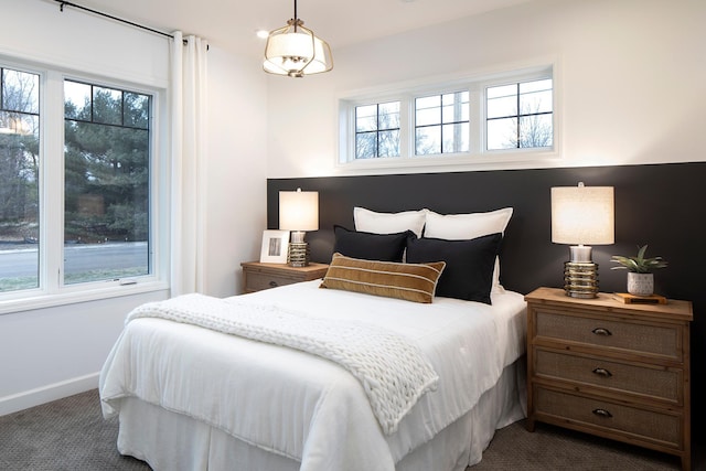 bedroom featuring dark colored carpet