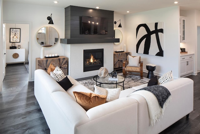 living room featuring dark wood-type flooring and a fireplace