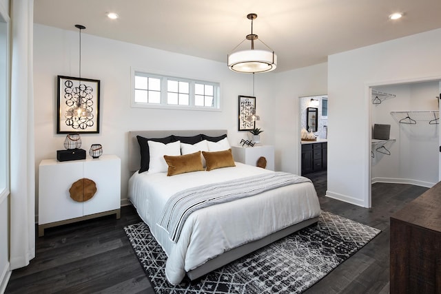 bedroom with ensuite bath and dark hardwood / wood-style flooring