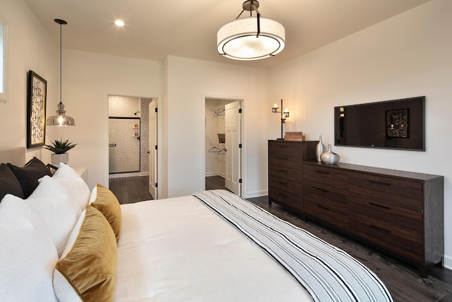 bedroom with ensuite bathroom and dark hardwood / wood-style flooring