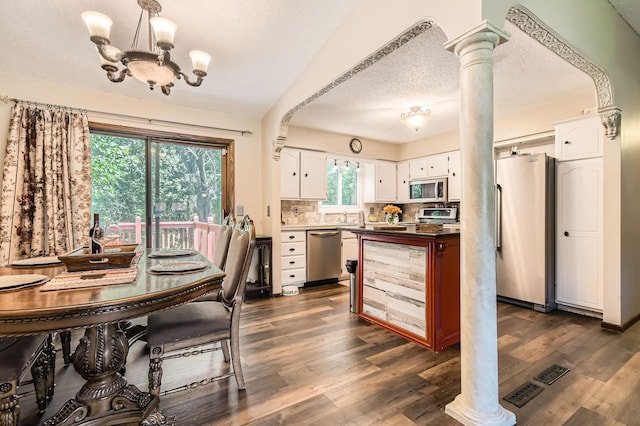 11132 100th Pl N, Maple Grove, MN 55369 - dining area featuring a chandelier, dark wood-style floors, ornate columns, and a textured ceiling