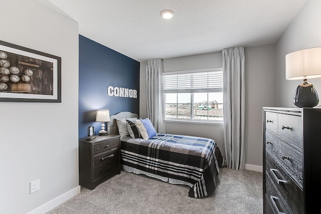 carpeted bedroom featuring a textured ceiling