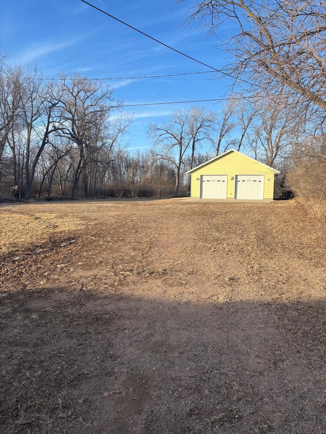 view of yard with a garage and an outdoor structure