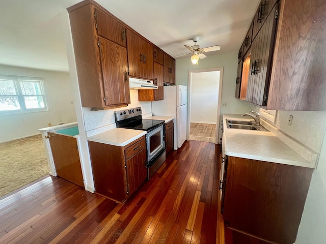 kitchen featuring sink, stainless steel range with electric stovetop, dark hardwood / wood-style floors, white fridge, and ceiling fan