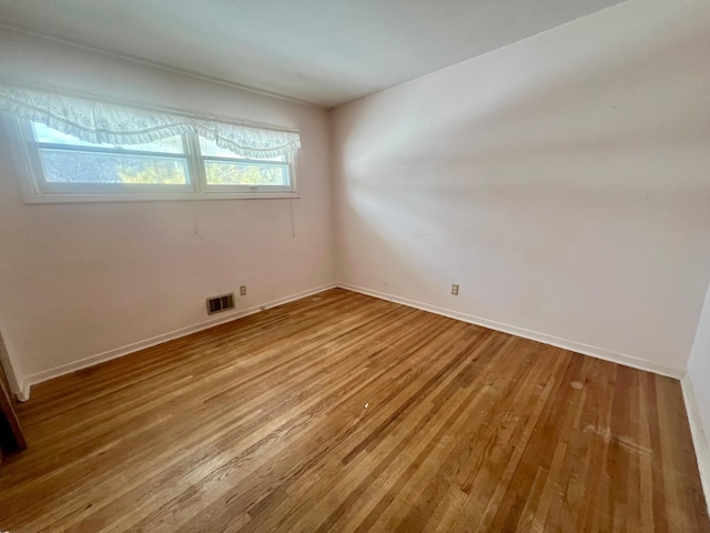 spare room with wood-type flooring