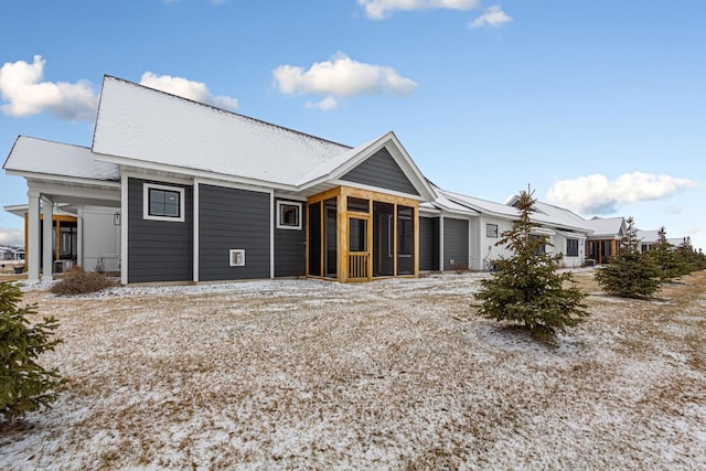 rear view of property with a sunroom