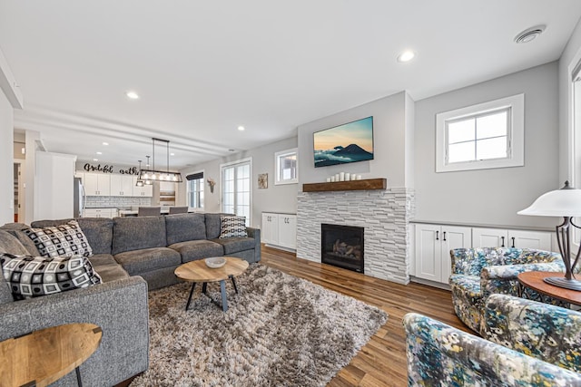 living room with wood-type flooring and a fireplace