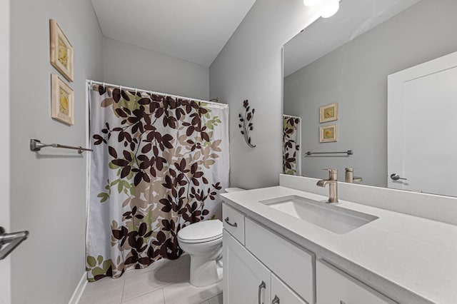 bathroom featuring vanity, tile patterned flooring, and toilet