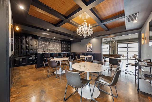 dining area with coffered ceiling, beam ceiling, and an inviting chandelier