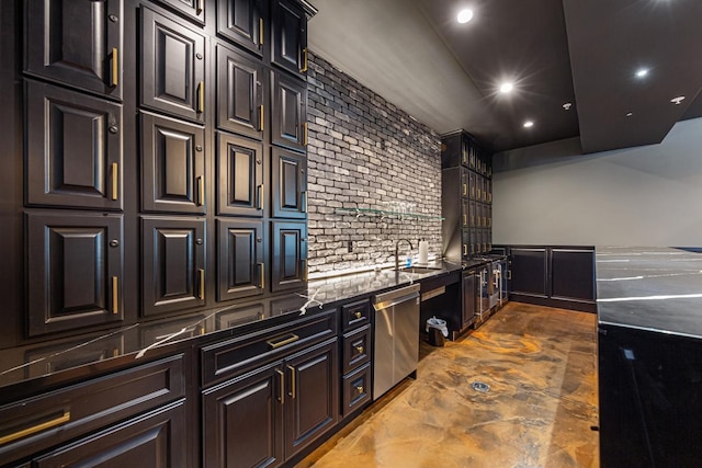 kitchen featuring stainless steel dishwasher, dark stone counters, and sink