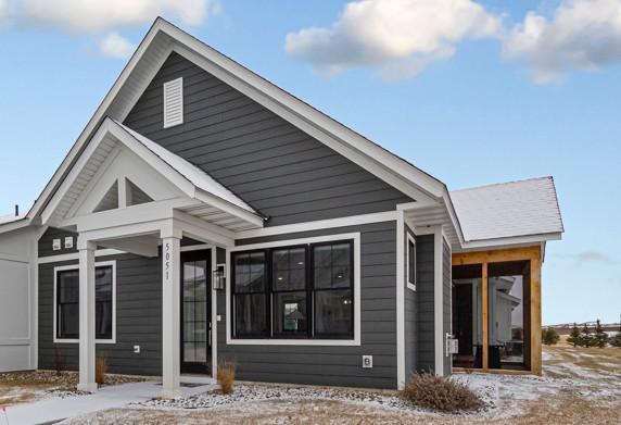 5051 216th St W, Farmington, MN 55024 - snow covered house featuring a sunroom