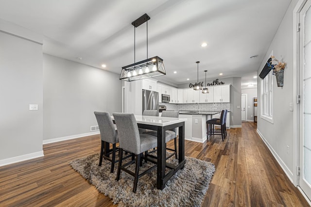 5051 216th St W, Farmington, MN 55024 - dining space featuring dark wood-style floors, recessed lighting, baseboards, and a chandelier