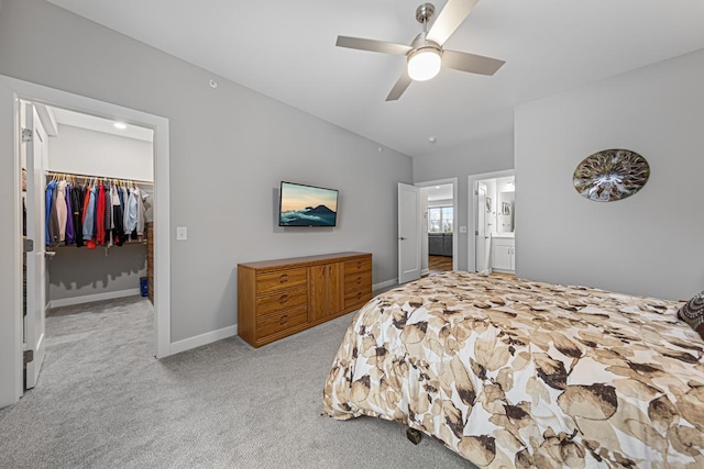 5051 216th St W, Farmington, MN 55024 - bedroom featuring a walk in closet, carpet, a closet, baseboards, and a ceiling fan
