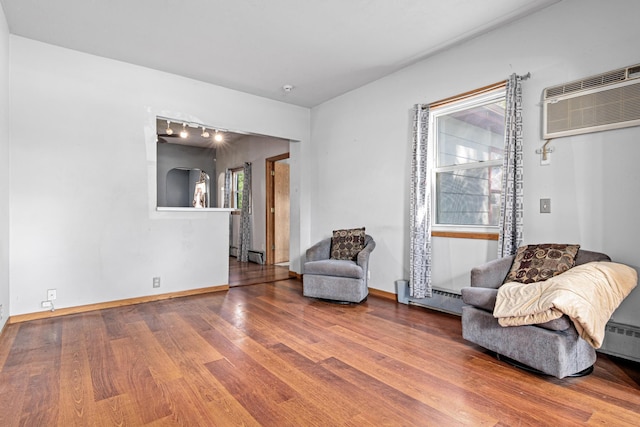 990 Virginia St, Saint Paul, MN 55117 - living area with wood finished floors, a wall mounted AC, and a baseboard radiator