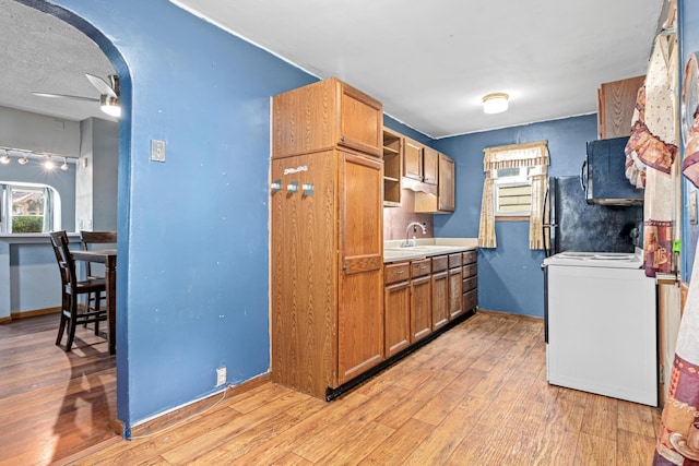 990 Virginia St, Saint Paul, MN 55117 - kitchen with black microwave, stove, light wood-type flooring, and ceiling fan