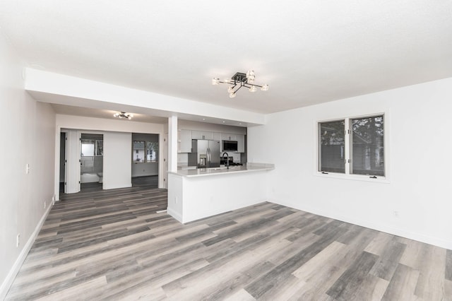 unfurnished living room featuring hardwood / wood-style floors and a textured ceiling