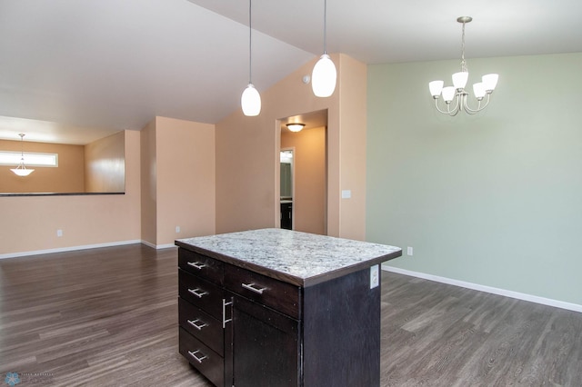 kitchen featuring open floor plan, hanging light fixtures, and dark wood finished floors