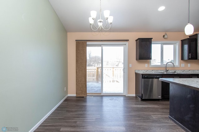 kitchen featuring pendant lighting, light countertops, dark brown cabinets, and stainless steel dishwasher