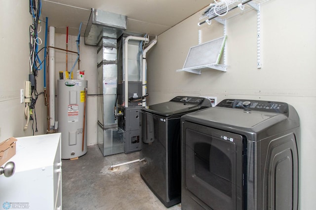 laundry room featuring washer and dryer, laundry area, water heater, and heating unit