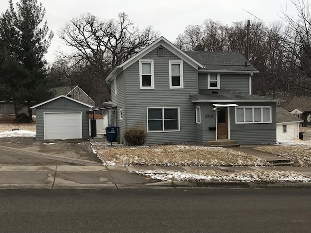 front facade featuring a garage and an outdoor structure