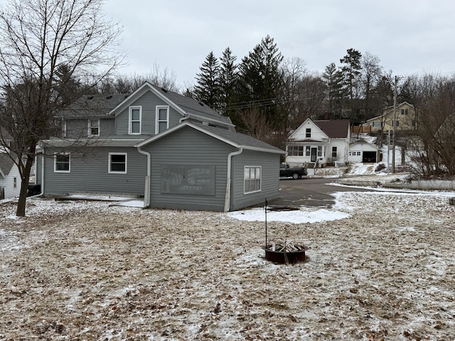 view of snow covered rear of property