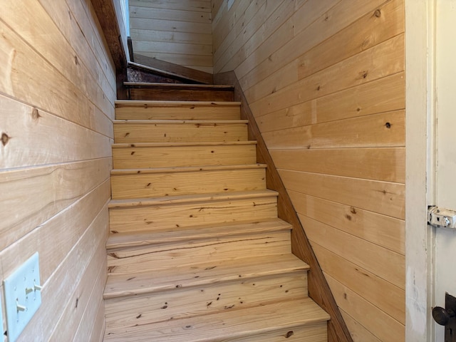 staircase with wooden walls