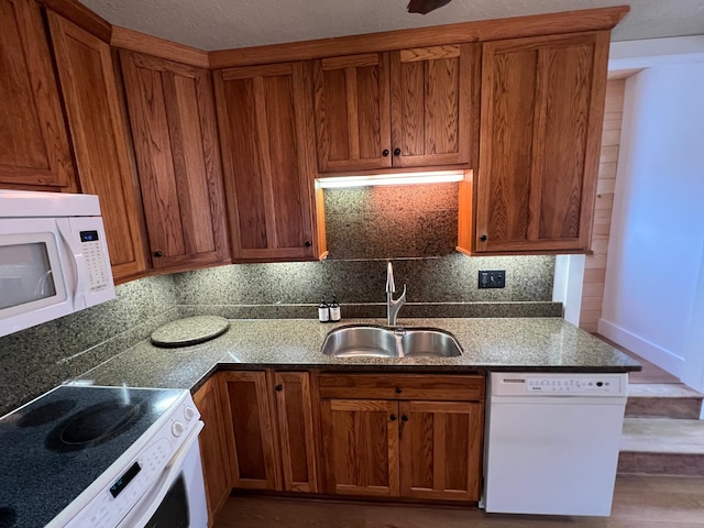 kitchen with white appliances, sink, and tasteful backsplash