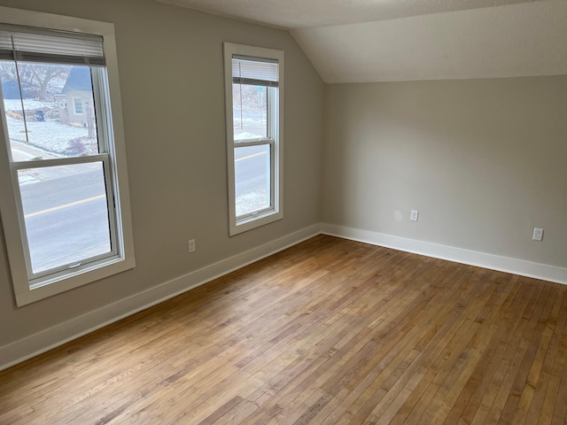 bonus room featuring light hardwood / wood-style flooring and lofted ceiling