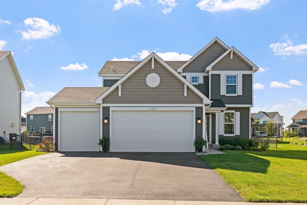 view of front of house with a garage and a front yard